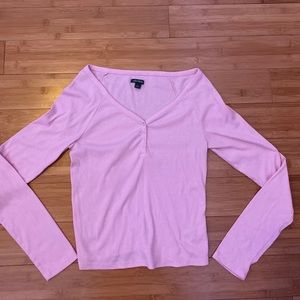 Pink long sleeved shirt with buttons.